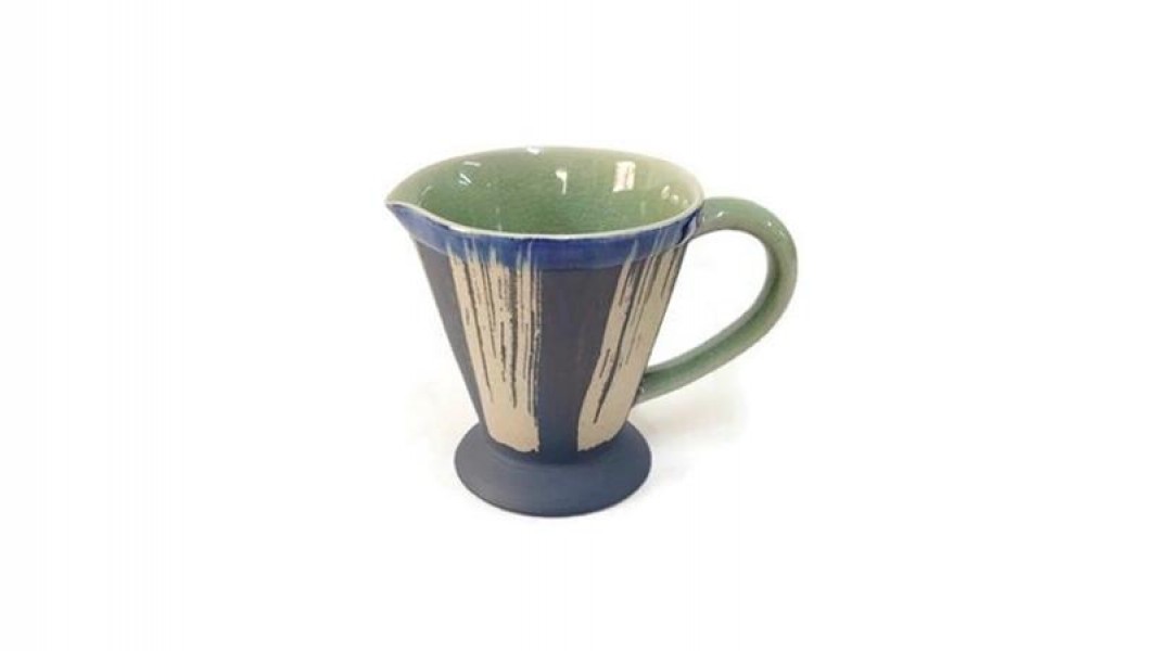 Pitcher with ground coffee design