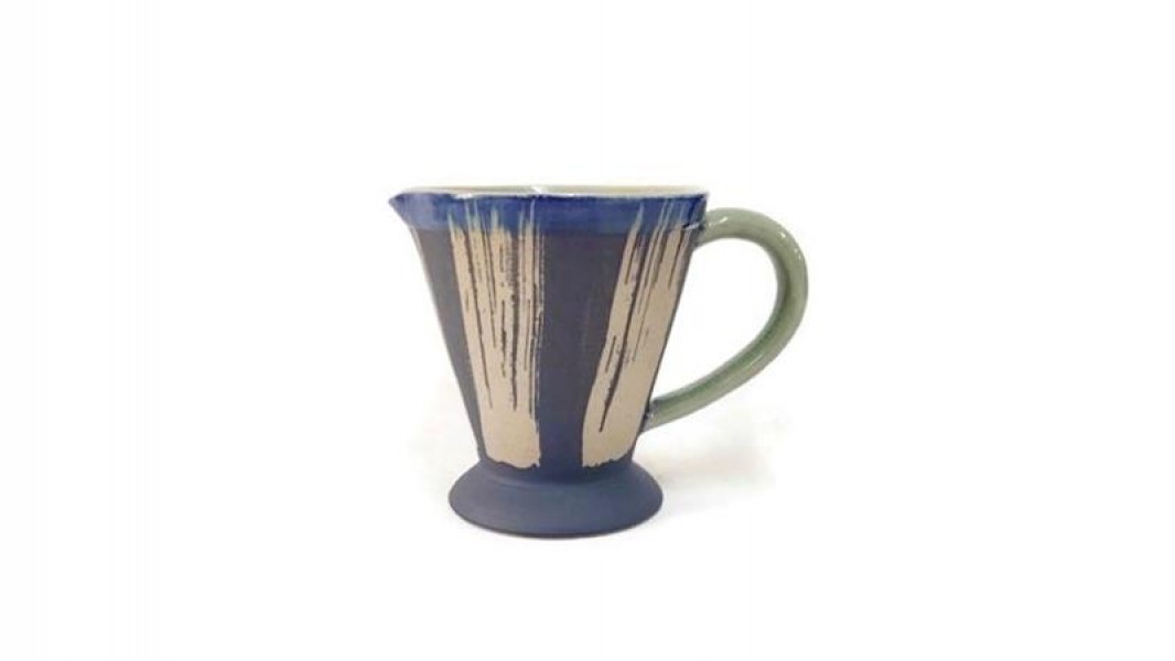 Pitcher with ground coffee design